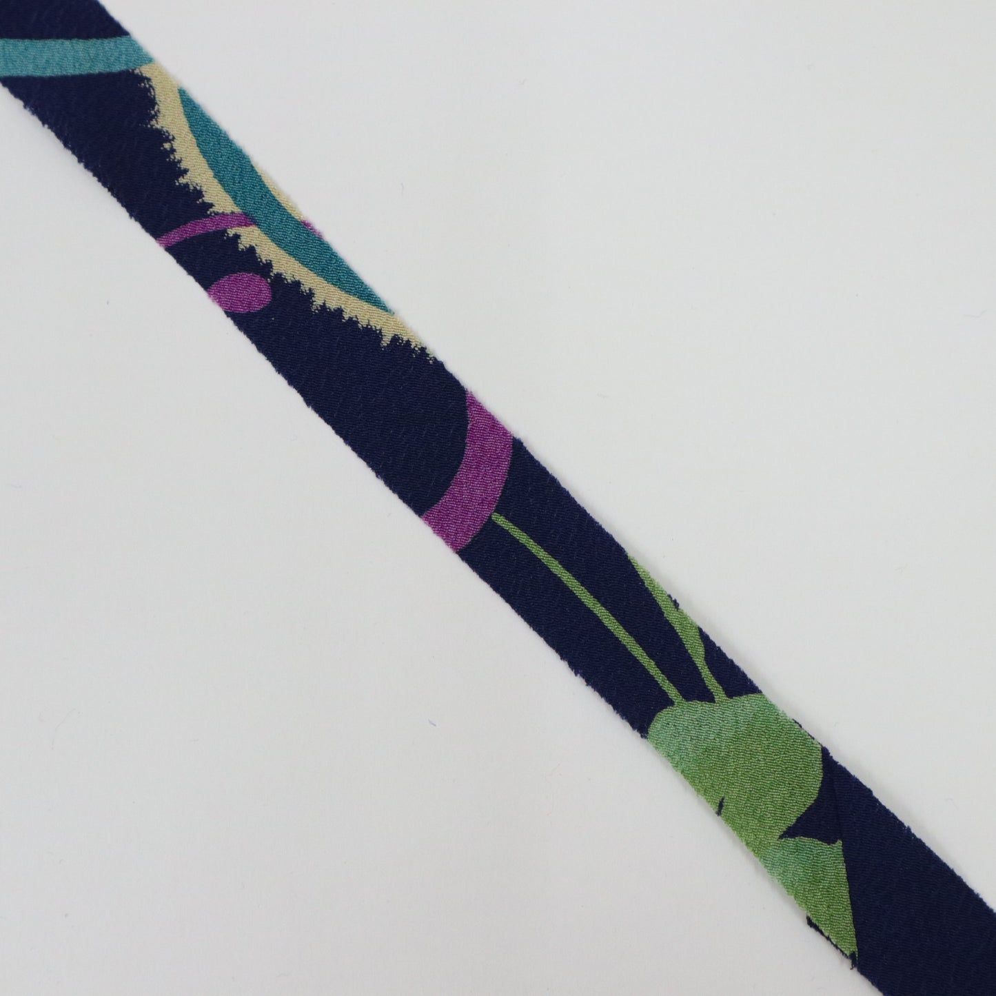 Dark blue with floral and leaf patterns in yellow-green, light blue, white, and purple (Y02312006)