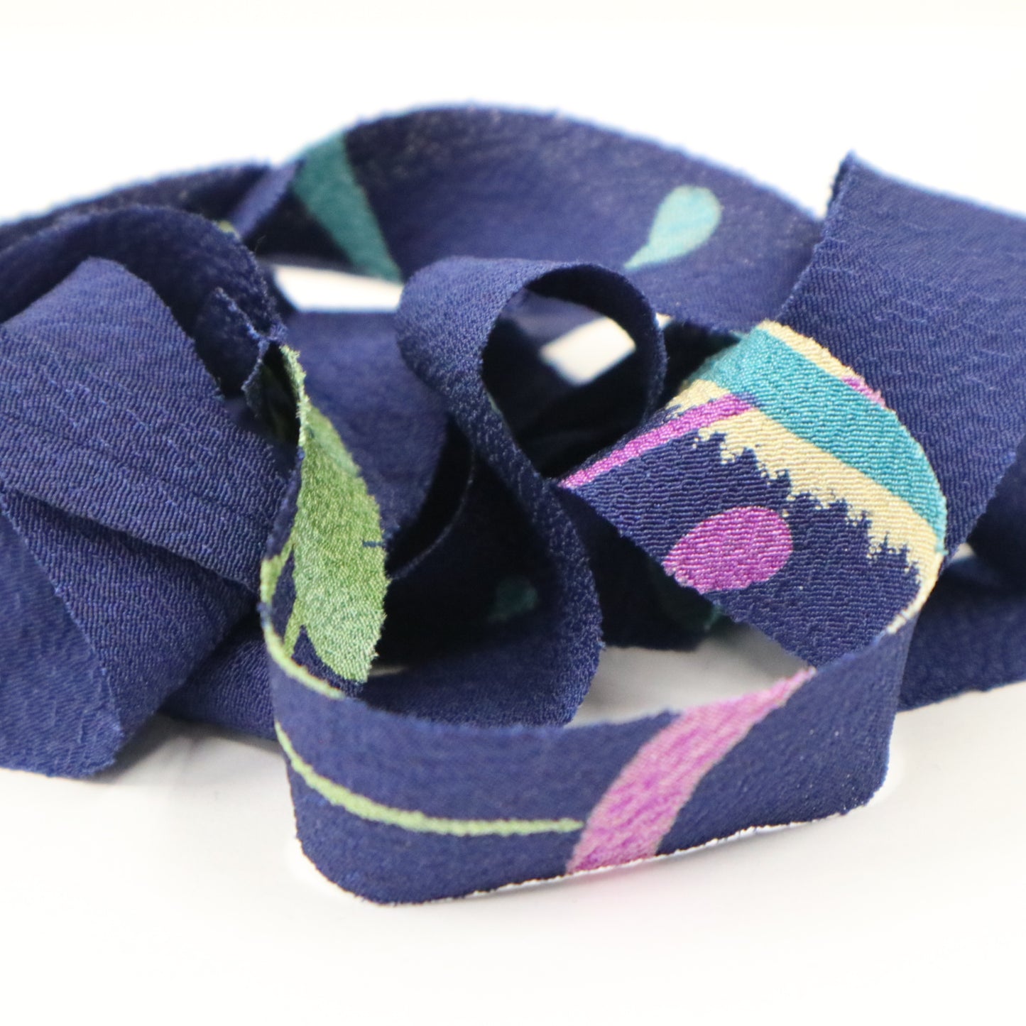 Dark blue with floral and leaf patterns in yellow-green, light blue, white, and purple (Y02312006)