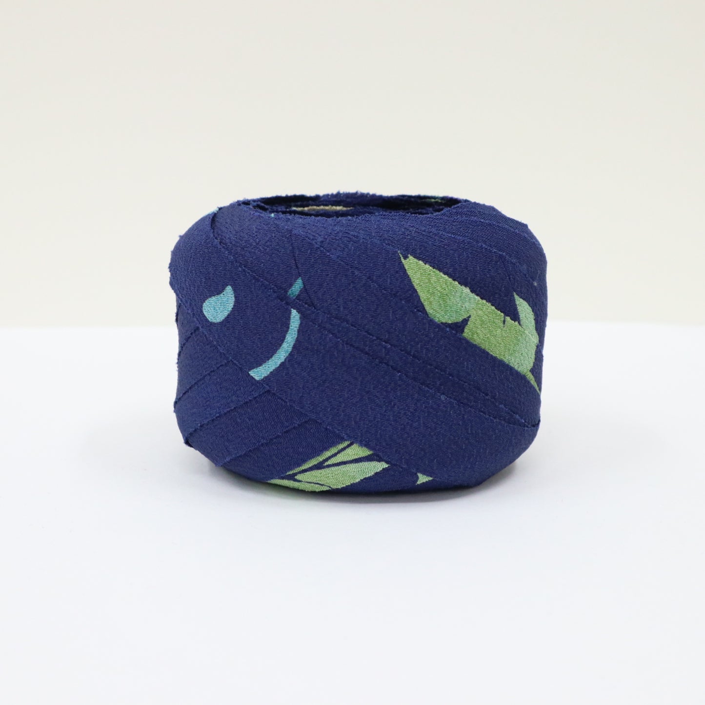 Dark blue with floral and leaf patterns in yellow-green, light blue, white, and purple (Y02312006)