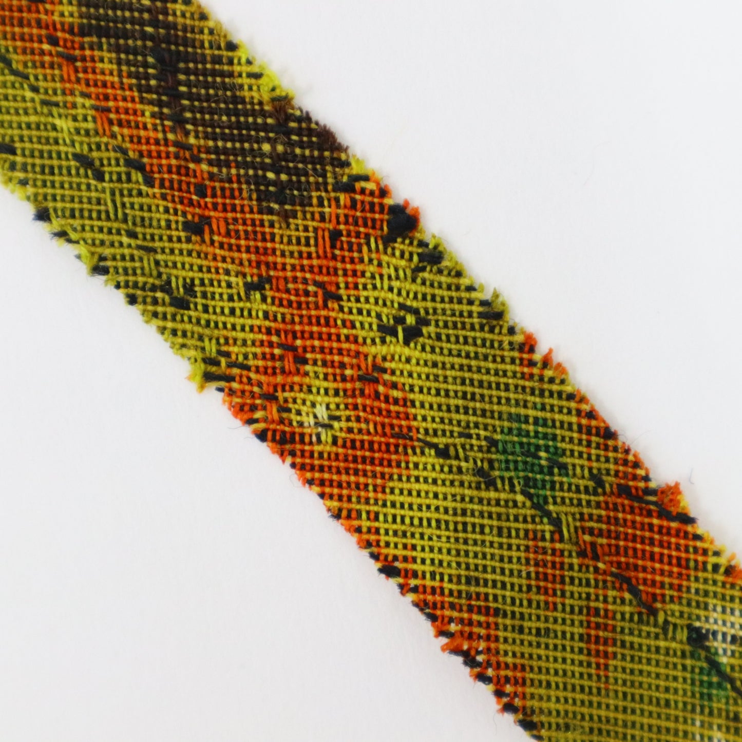 Mustard green with orange, yellow, green, brown, and white geometric pattern, interwoven (Y02405005)