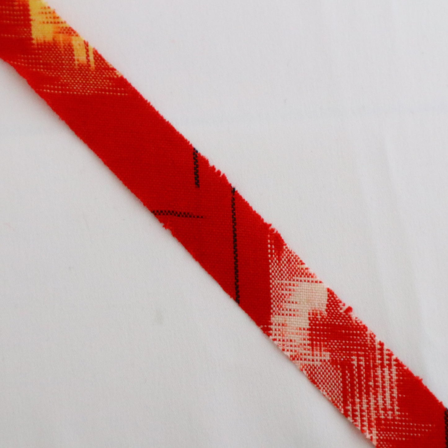 Red with yellow, white, and black ikat pattern, wool (Y02211006)