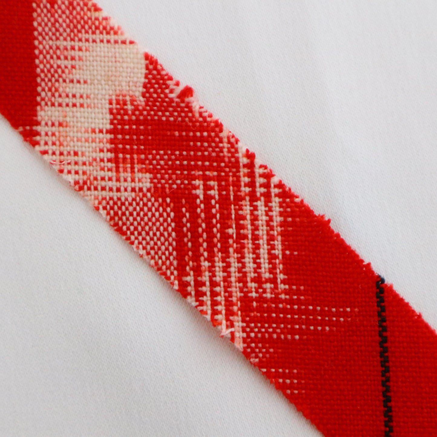 Red with yellow, white, and black ikat pattern, wool (Y02211006)