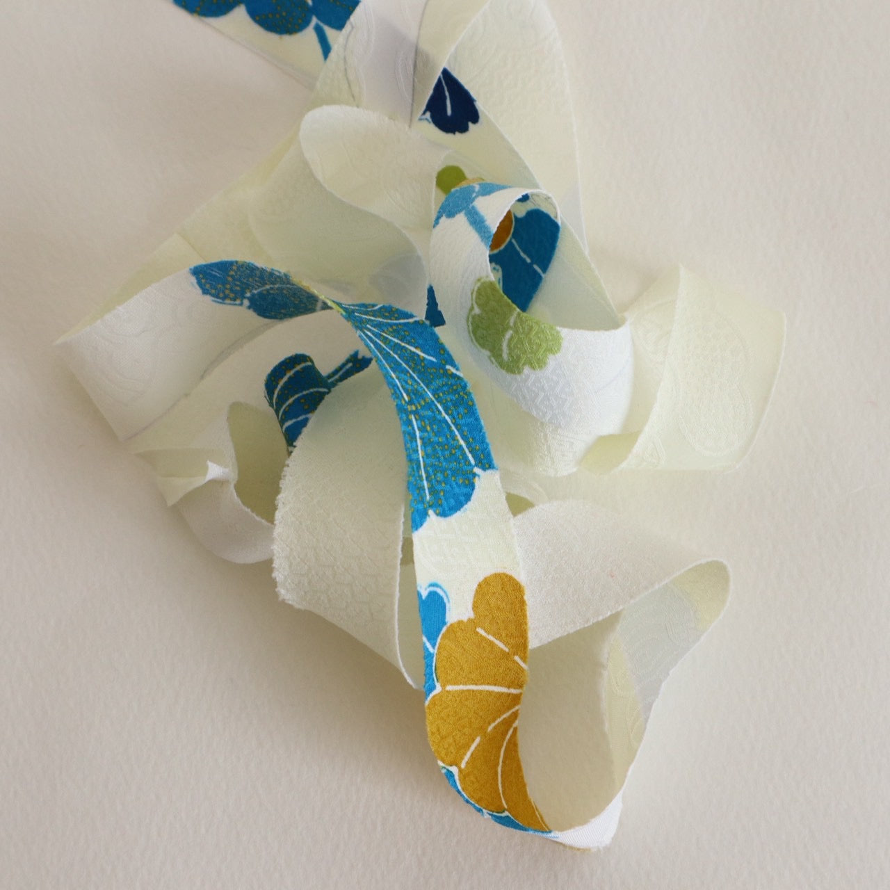 薄い卵色に赤・緑・青・黄の花柄・化繊(Y02601004）