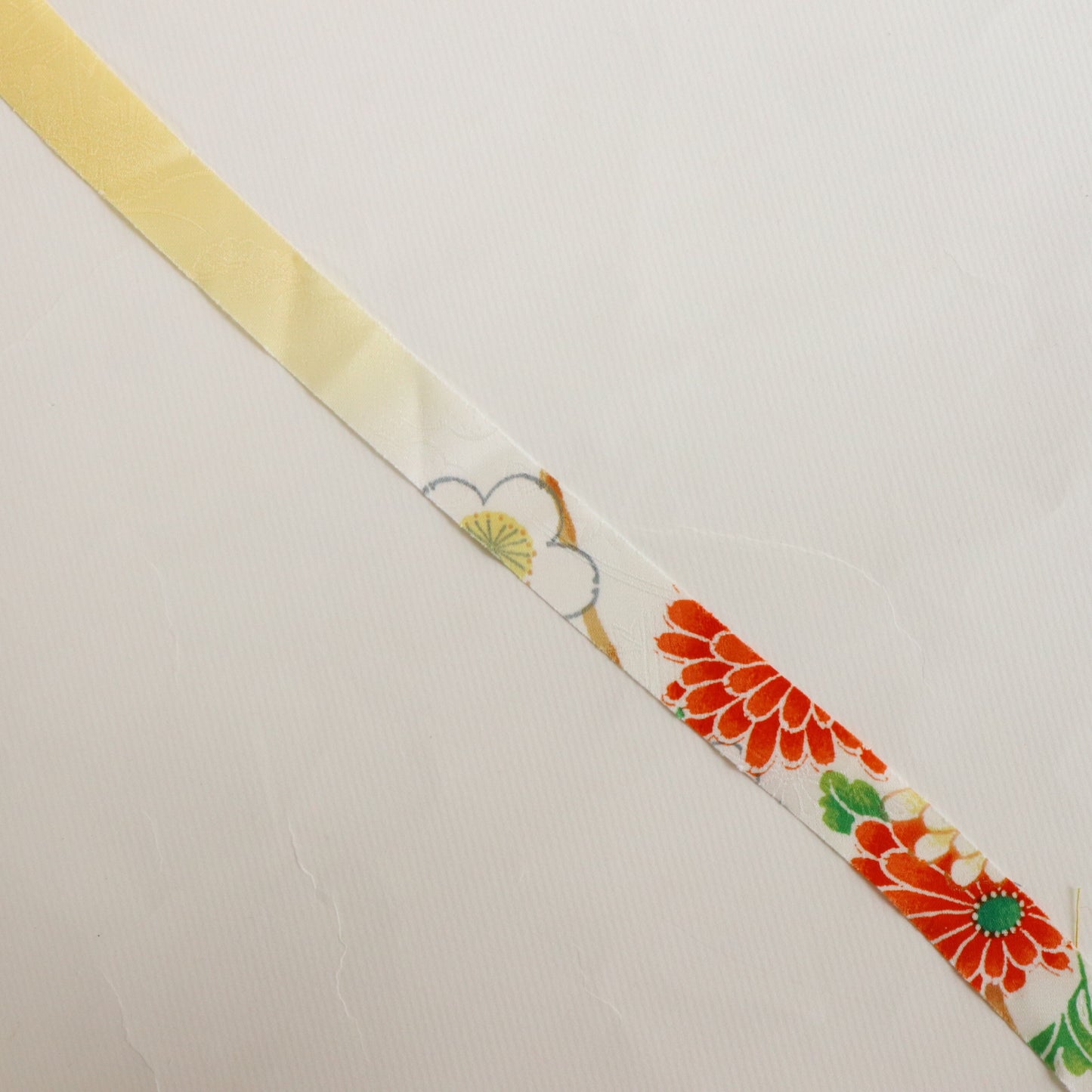 黄色にところどころ鮮やかな吉祥花柄・化繊　(Y02606006）