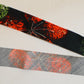 Muslin with red, yellow and green floral pattern on a black background (Y02507003)