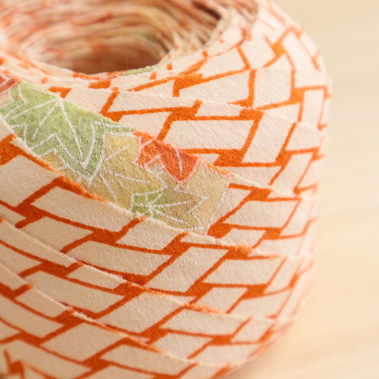 Orange wickerwork pattern on a white background with autumn leaves, plum and crepe (Y02008060)